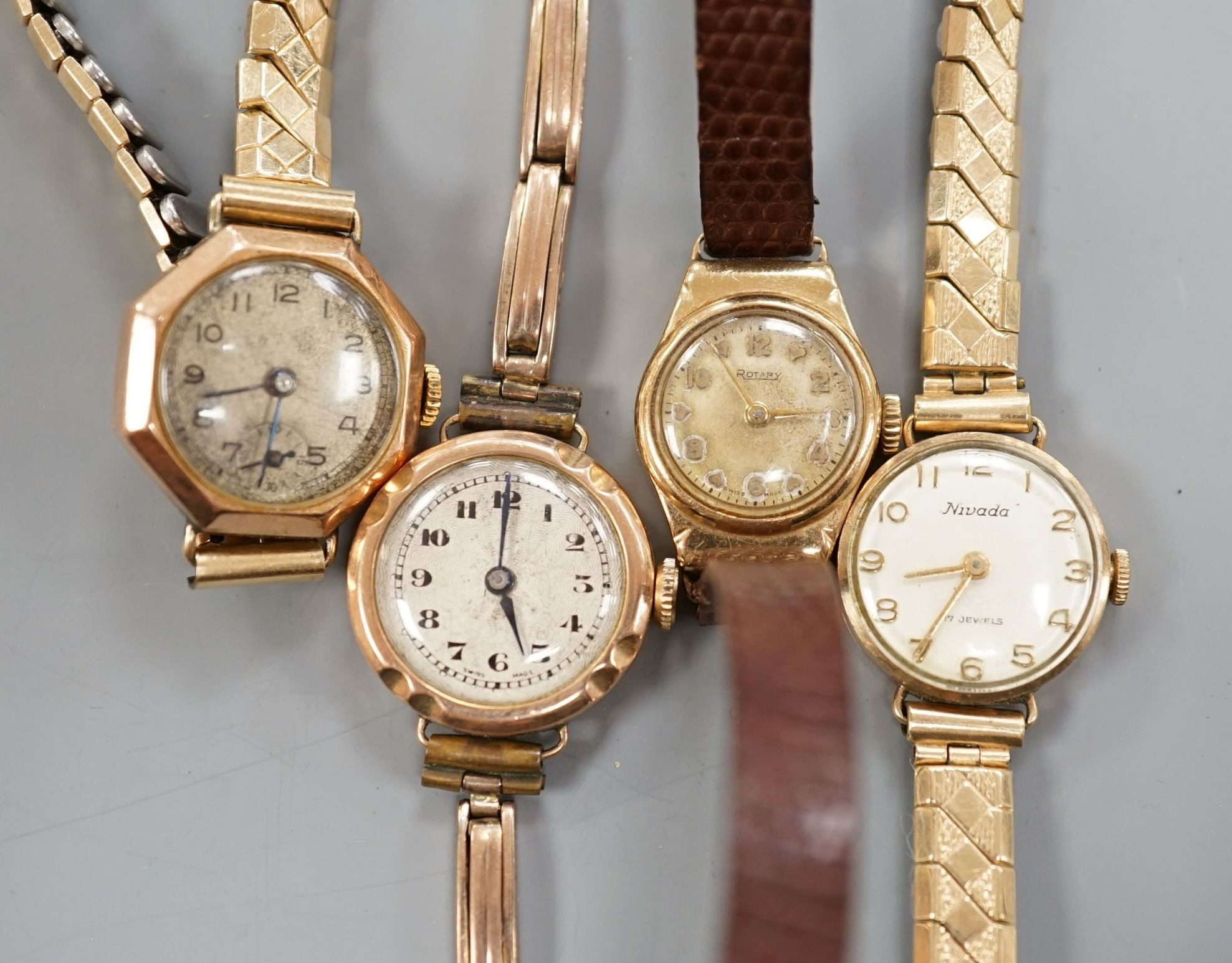 Three lady's early to mid 20th century 9ct gold manual wind wrist watches, one on a 9ct bracelet and one other yellow metal wrist watch